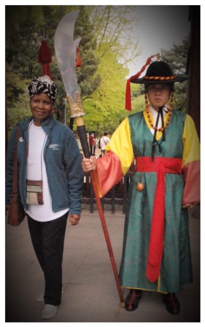 Two people dressed in korean costumes standing next to each other.