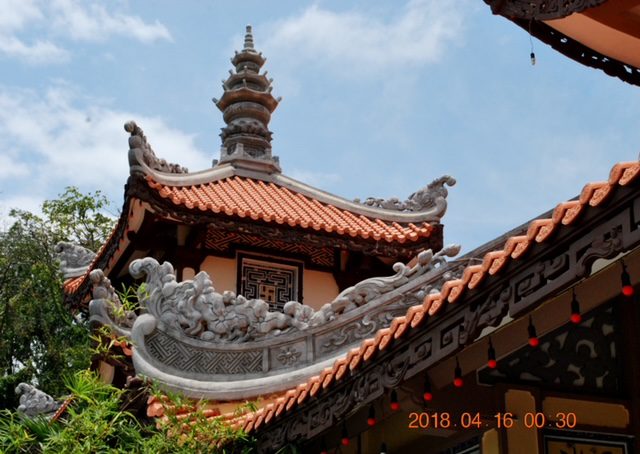 The roof of a chinese building with a tiled roof.